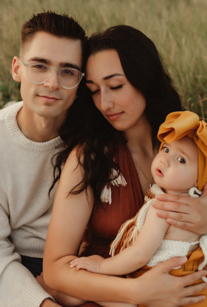 a mom and dad loving on their daughter while being photographed by a washington family photographer